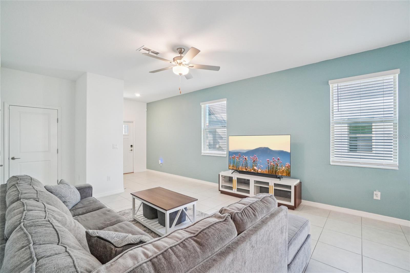 Living Room – Additional Angle – Another perspective showcasing the generous seating area and soft accent wall, creating a comfortable everyday living space.