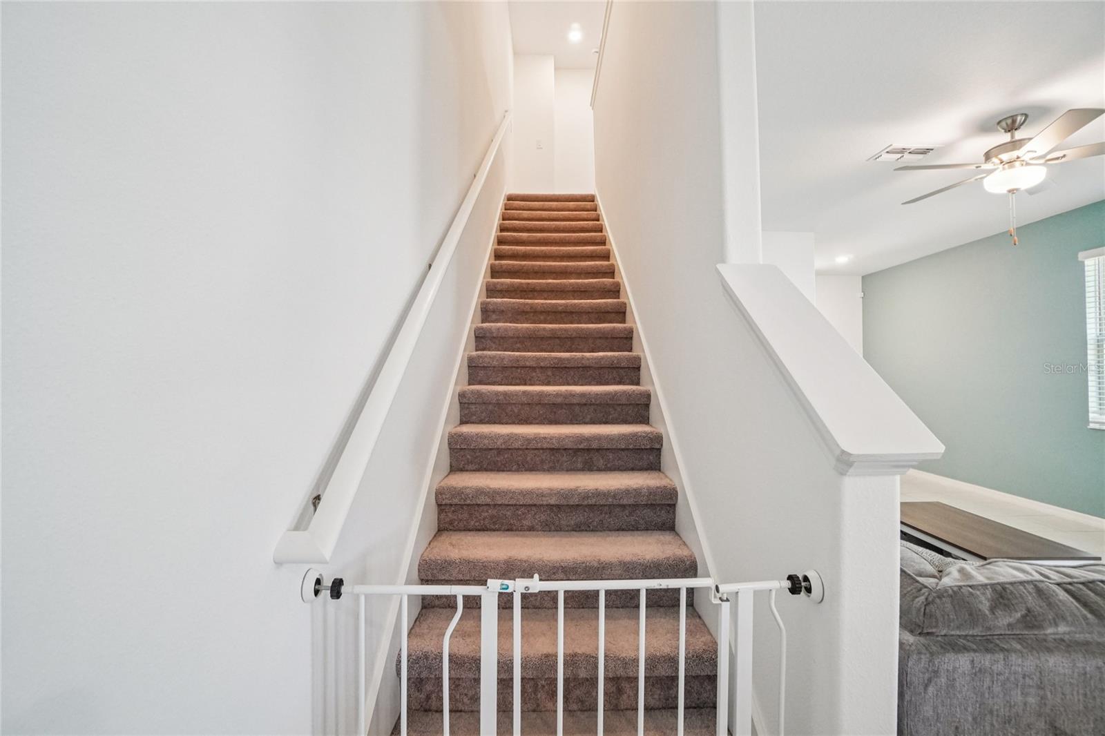 Staircase – Carpeted staircase leading to the second floor, positioned conveniently off the main living area.