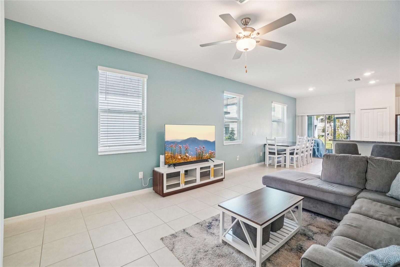 Main Living Area – Reverse Angle – An inviting open-concept layout connecting the living, dining, and kitchen spaces, ideal for both daily living and gathering.