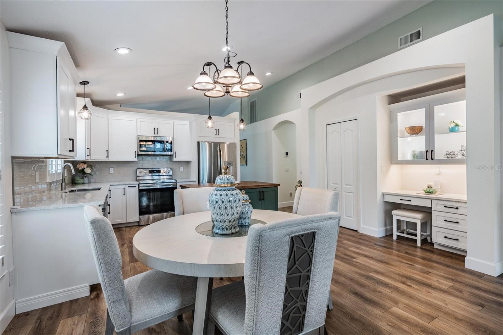 Thoughtful built-in desk with glass-front cabinets