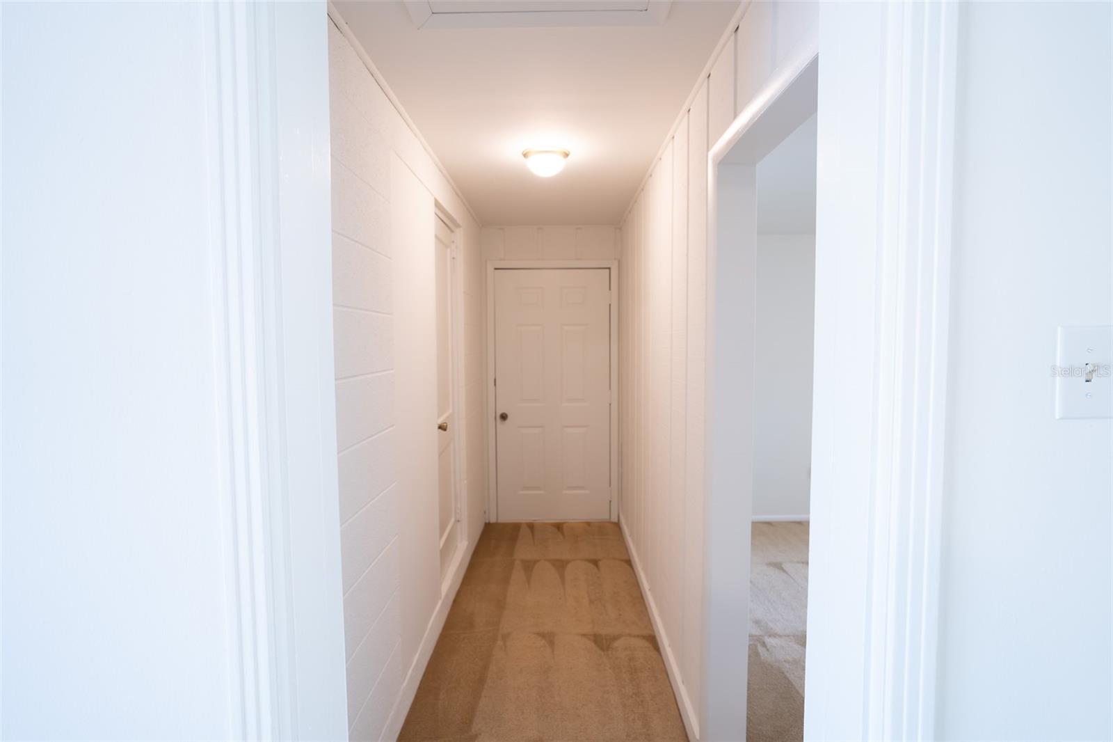 Hallway to half bath and bonus room