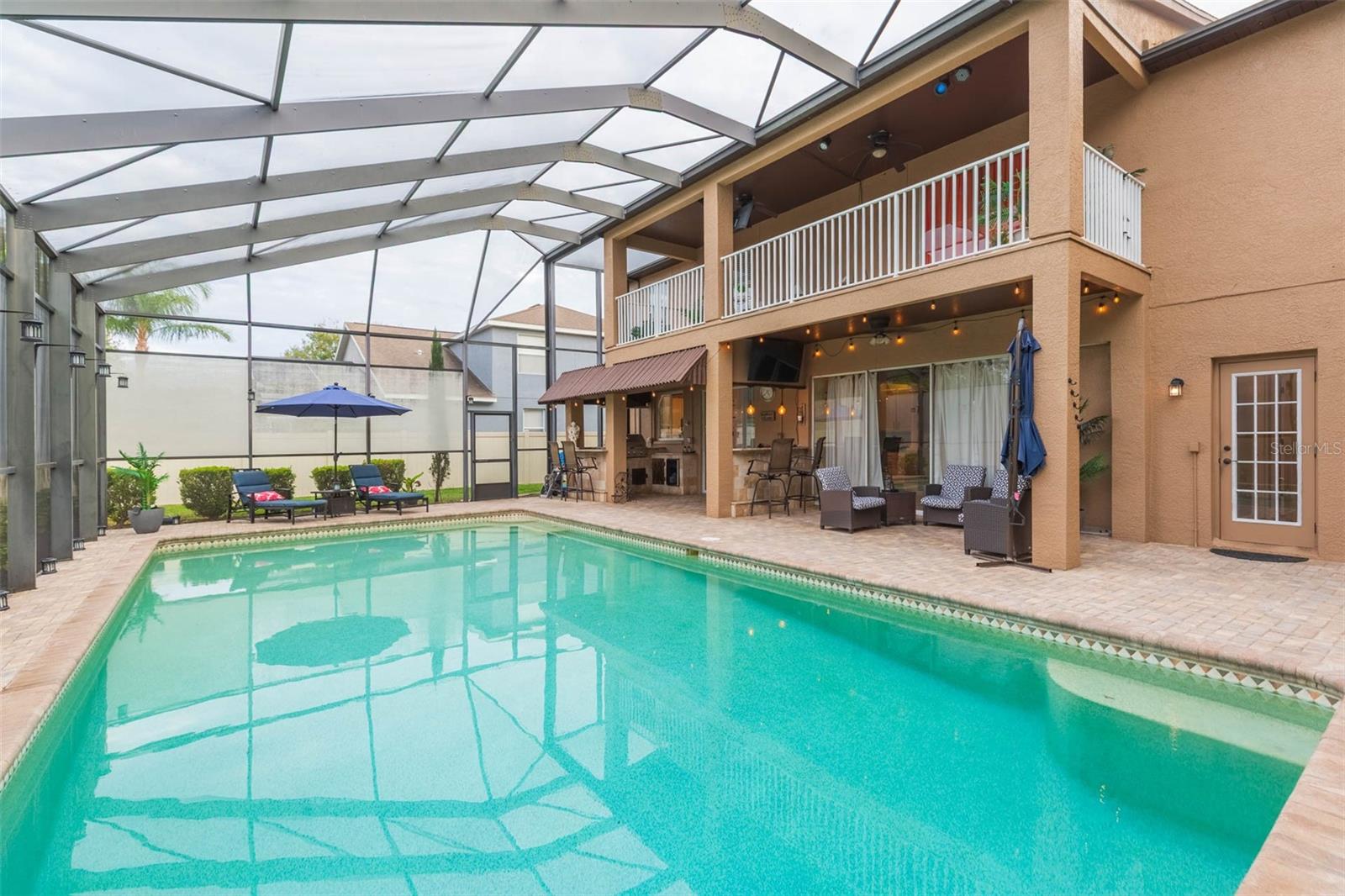 Two story lanai area with balcony attached to the primary bedroom