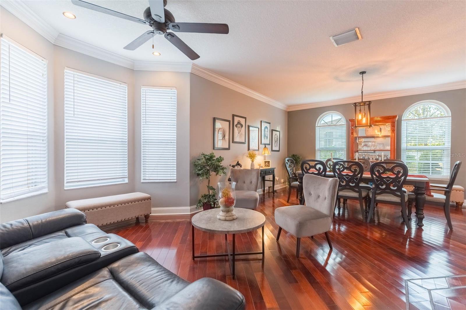 Formal living and dining rooms with huge windows and crown molding