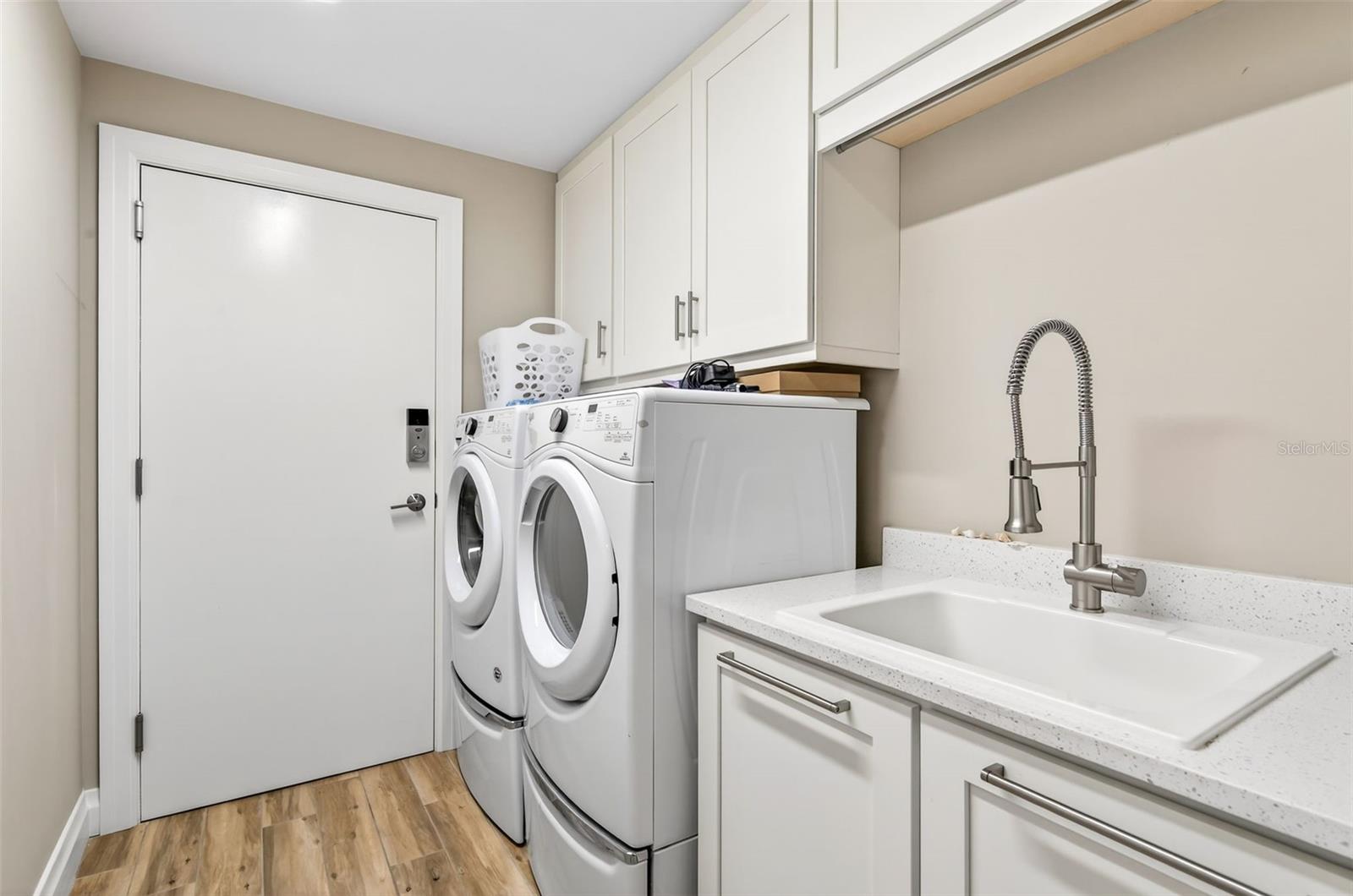 Washer/dryer w/utility sink, door to trash chute