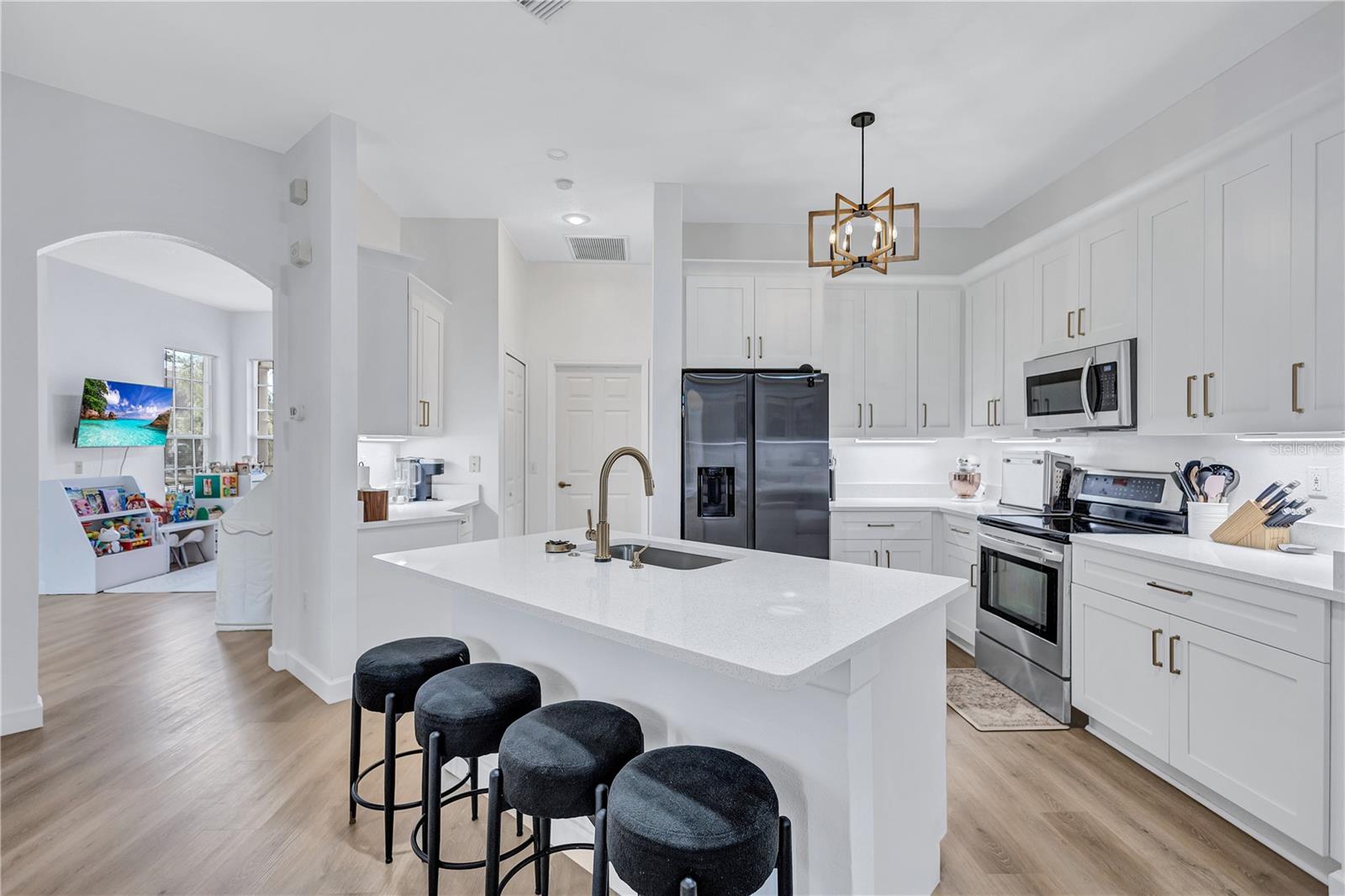 Completely remodeled kitchen featuring Quartz Counters with Island Sink, Soft Close solid wood Shaker cabinets and drawers. 100% Waterproof Parkay XPR 2.0 Luxury Vinyl Planking Flooring, New Modern LED Light Fixtures, Delta Touch 2.0 Faucet and Glass Rinser
