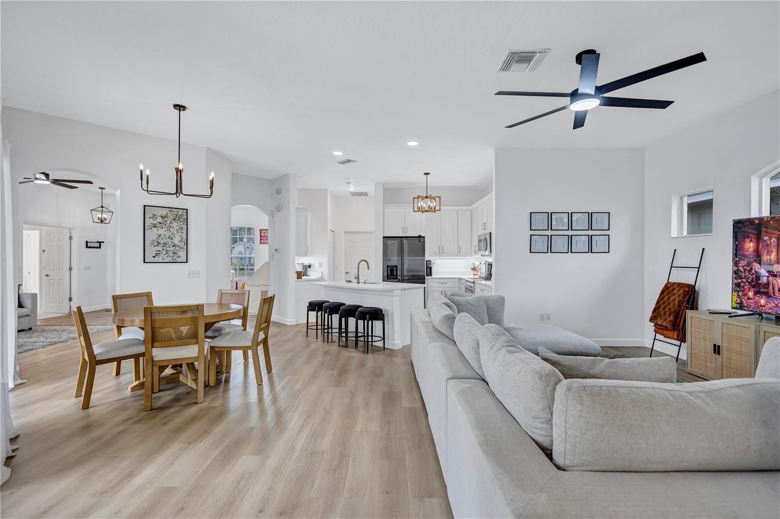 Large Eat-In Kitchen Area off Kitchen & Family Room featuring elegant chandelier and Modern lighted fans throughout the home