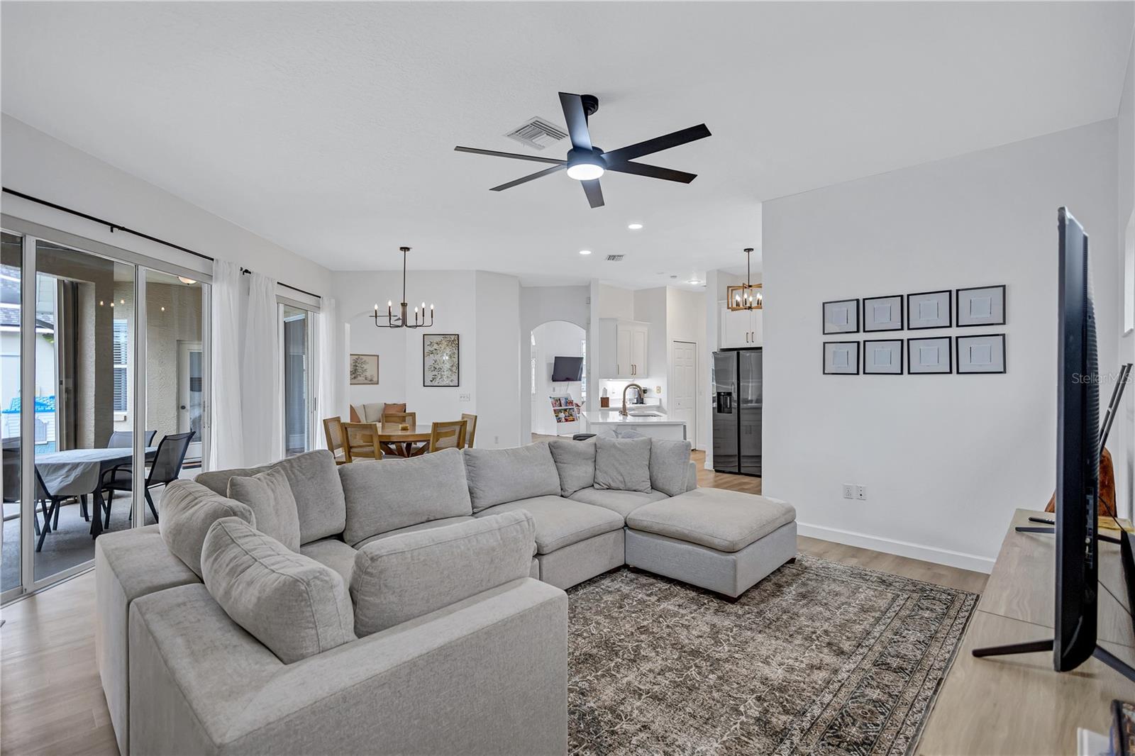 Tons of Natural Light through out home from multiple sets of glass sliding doors off pool deck