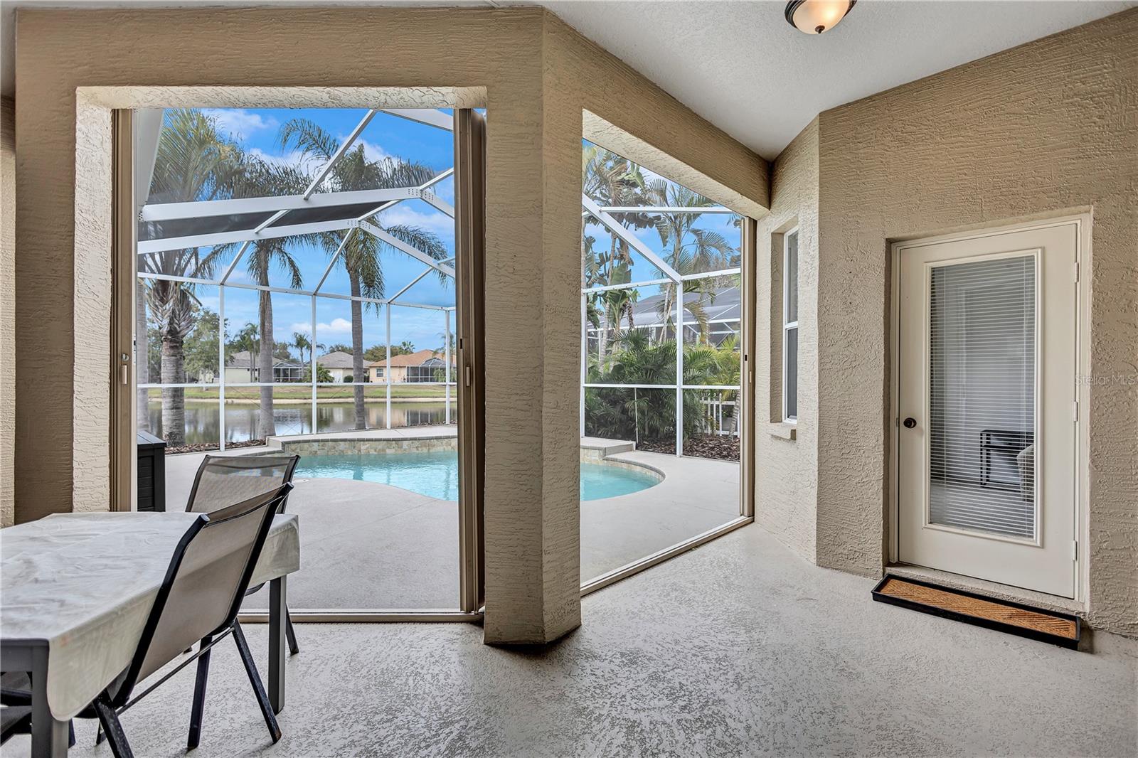 Covered Pool Deck Area. Notice the easy open close built in hurricane shutters.
