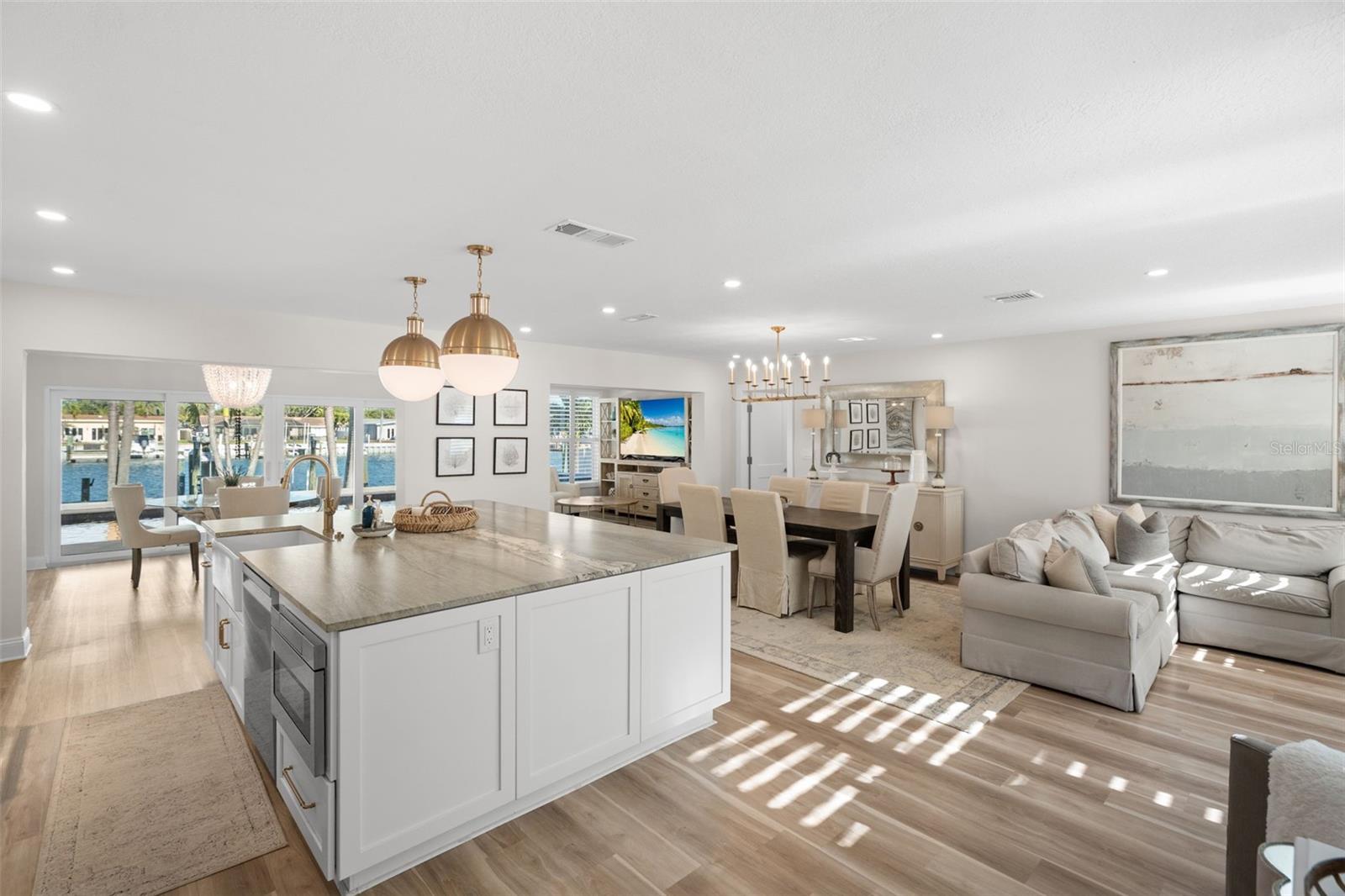 Open-concept layout with seamless flow from kitchen to living and dining.