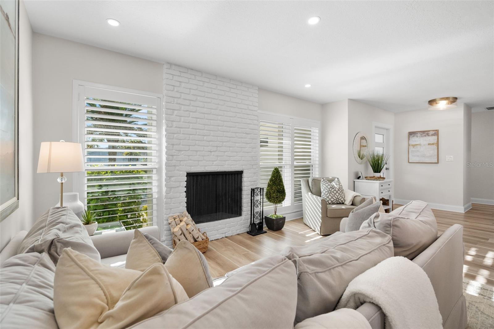 Bright living room featuring an updated fireplace and abundant natural light.