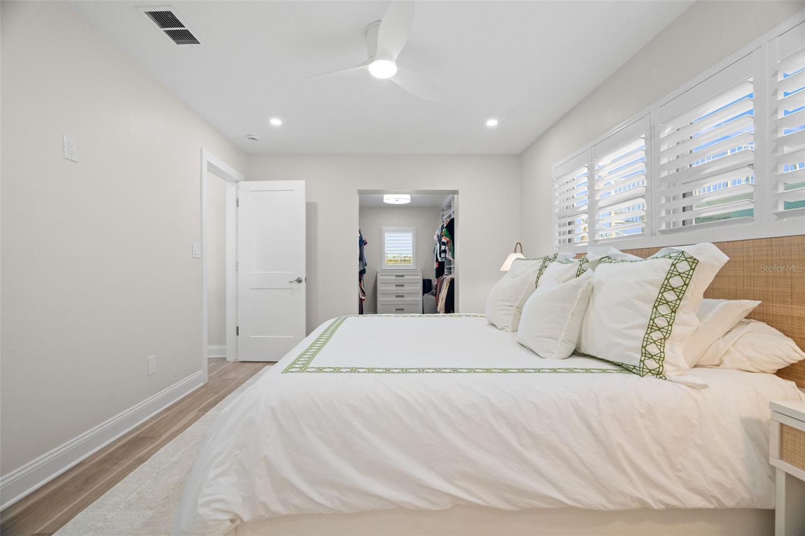 Spacious primary bedroom with updated flooring and natural light.