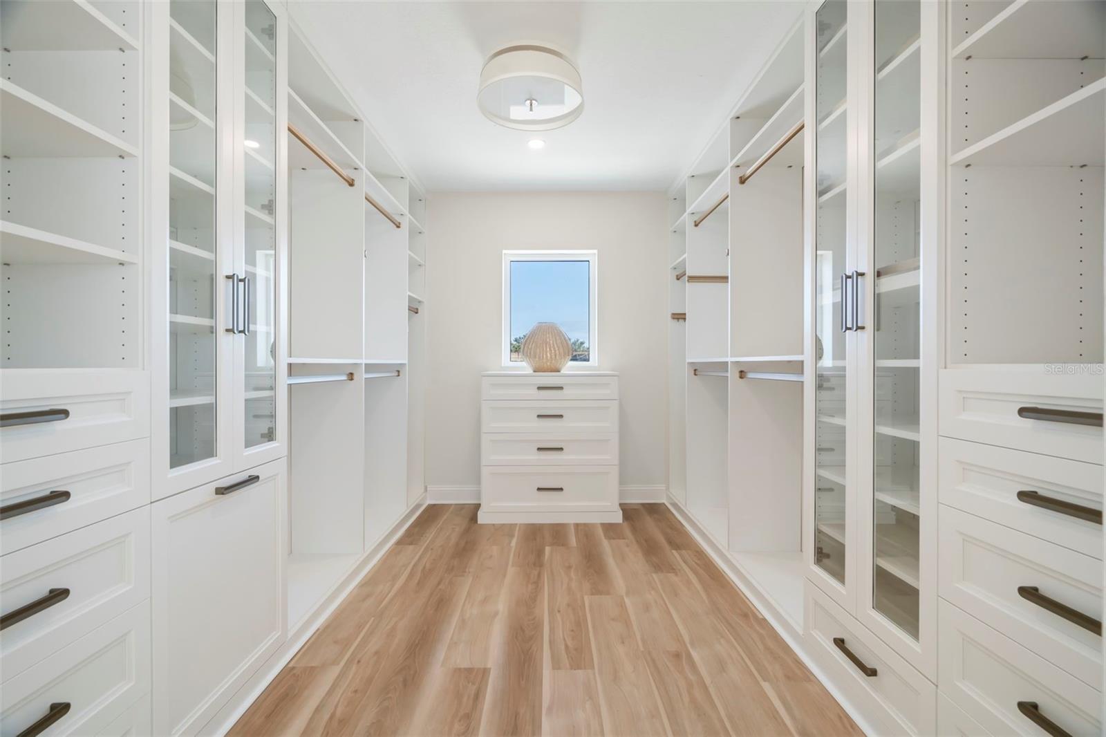 Custom Primary Bedroom outfitted with full wall custom cabinetry and storage.