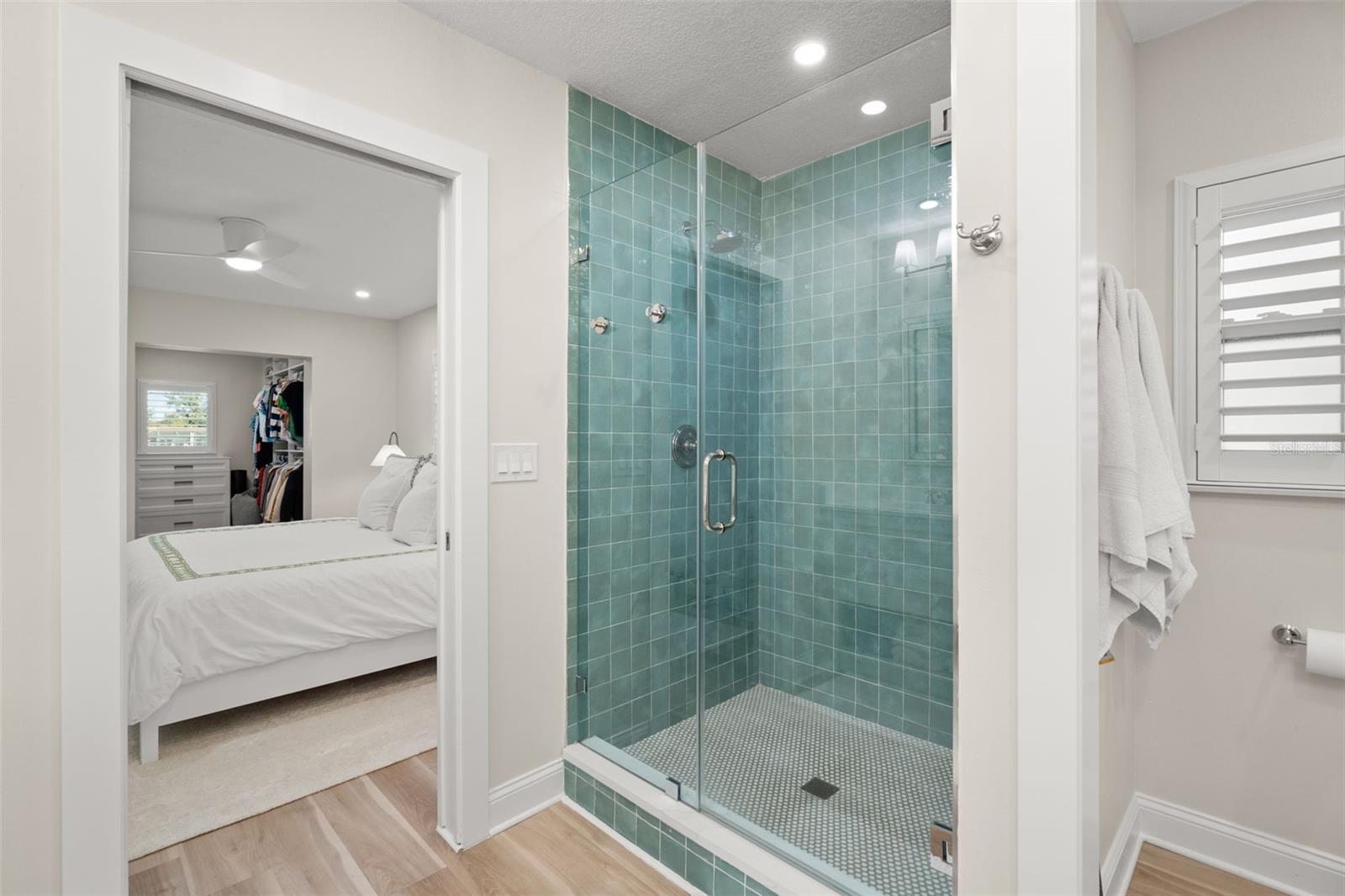 Beautiful walk-in shower featuring designer tilework.