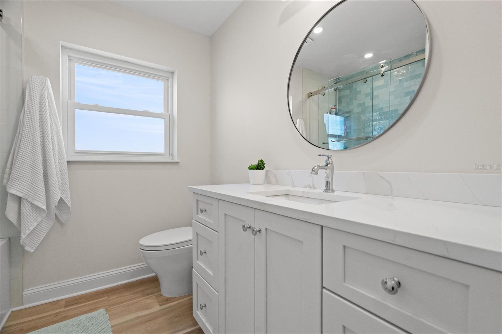 Clean and bright guest bathroom with updated fixtures.