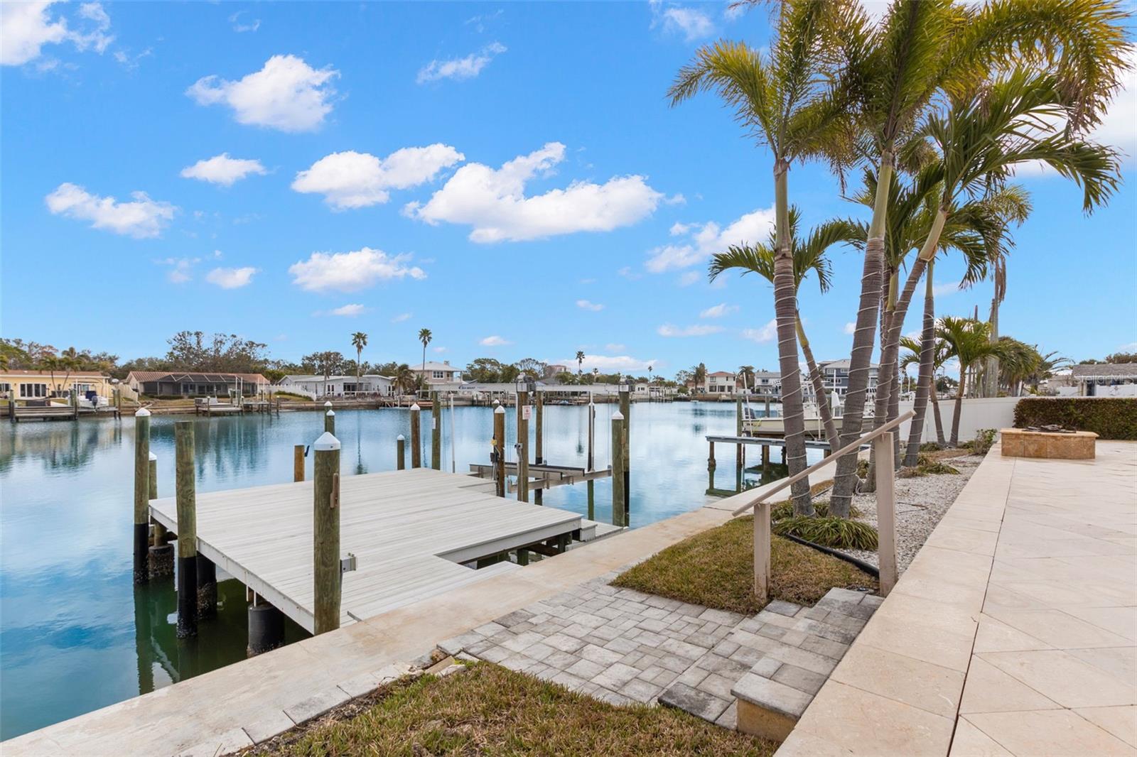 Beautiful waterfront setting showcasing pool, spa, and expansive outdoor living.