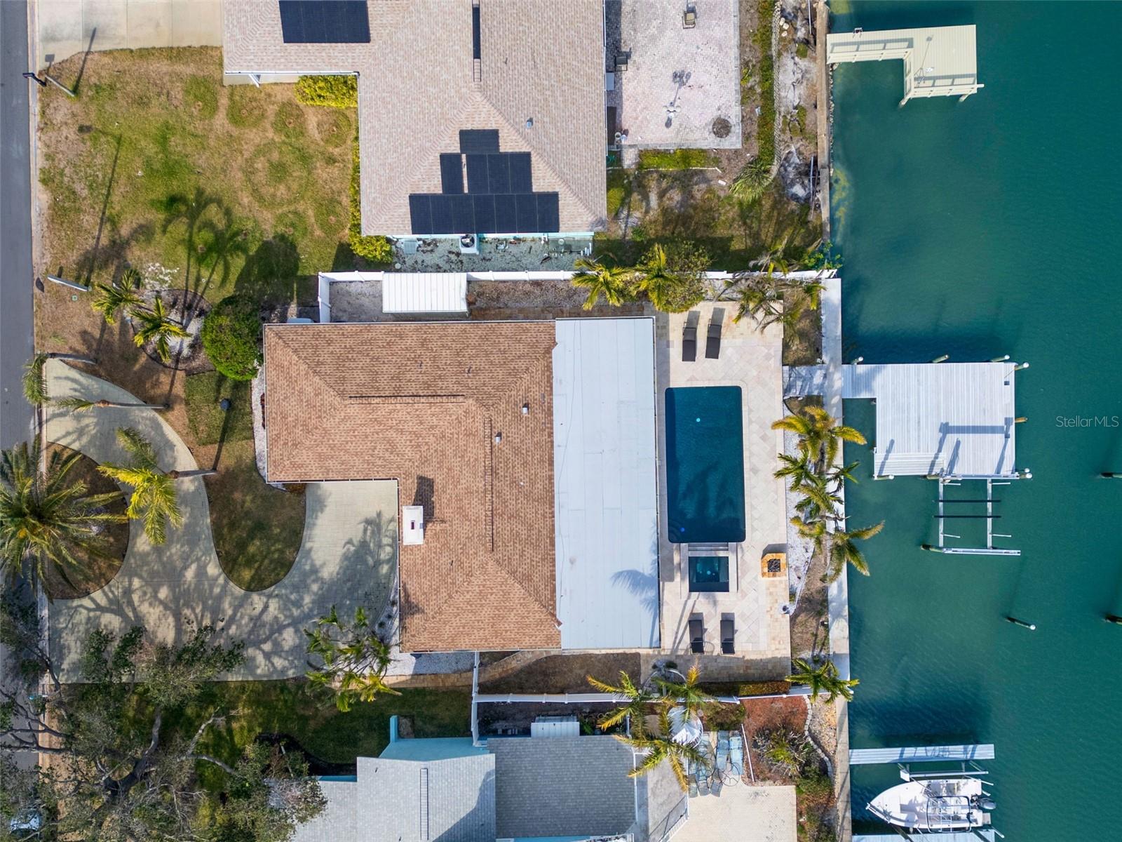 Direct overhead showing lot, pool, dock, and waterfront orientation.