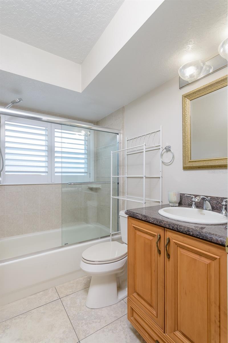 Hall bathroom with tub and shower