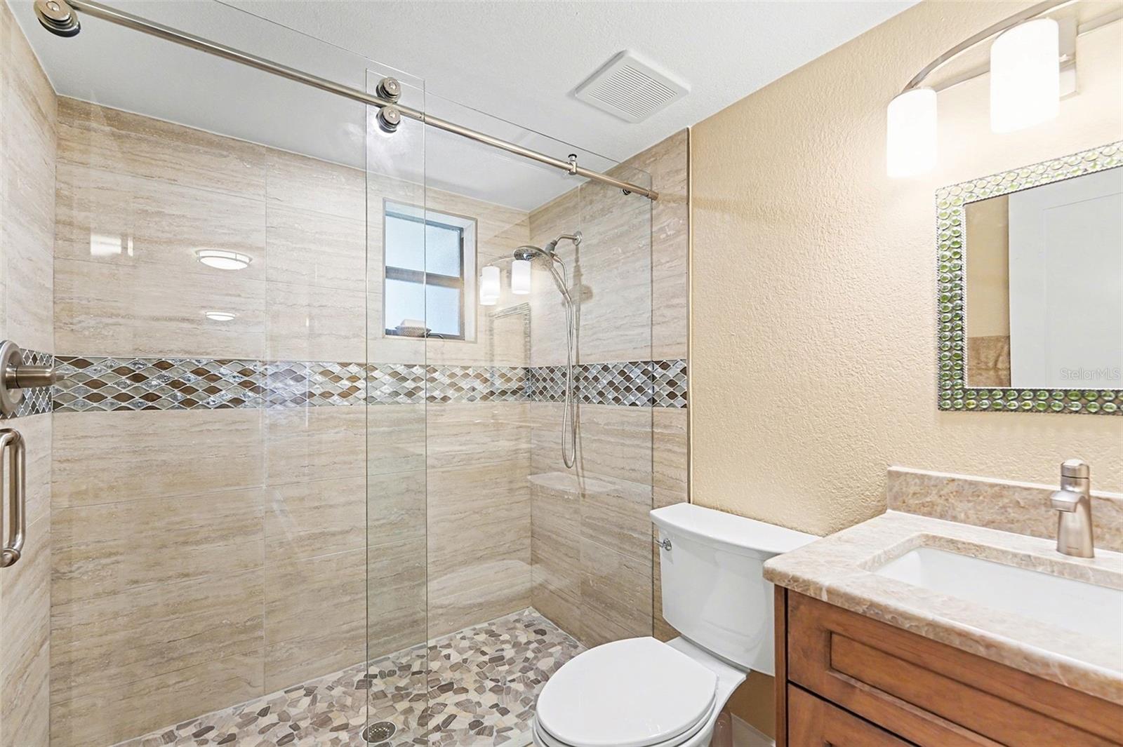 Second bathroom, updated with new countertop, flooring, and paint.