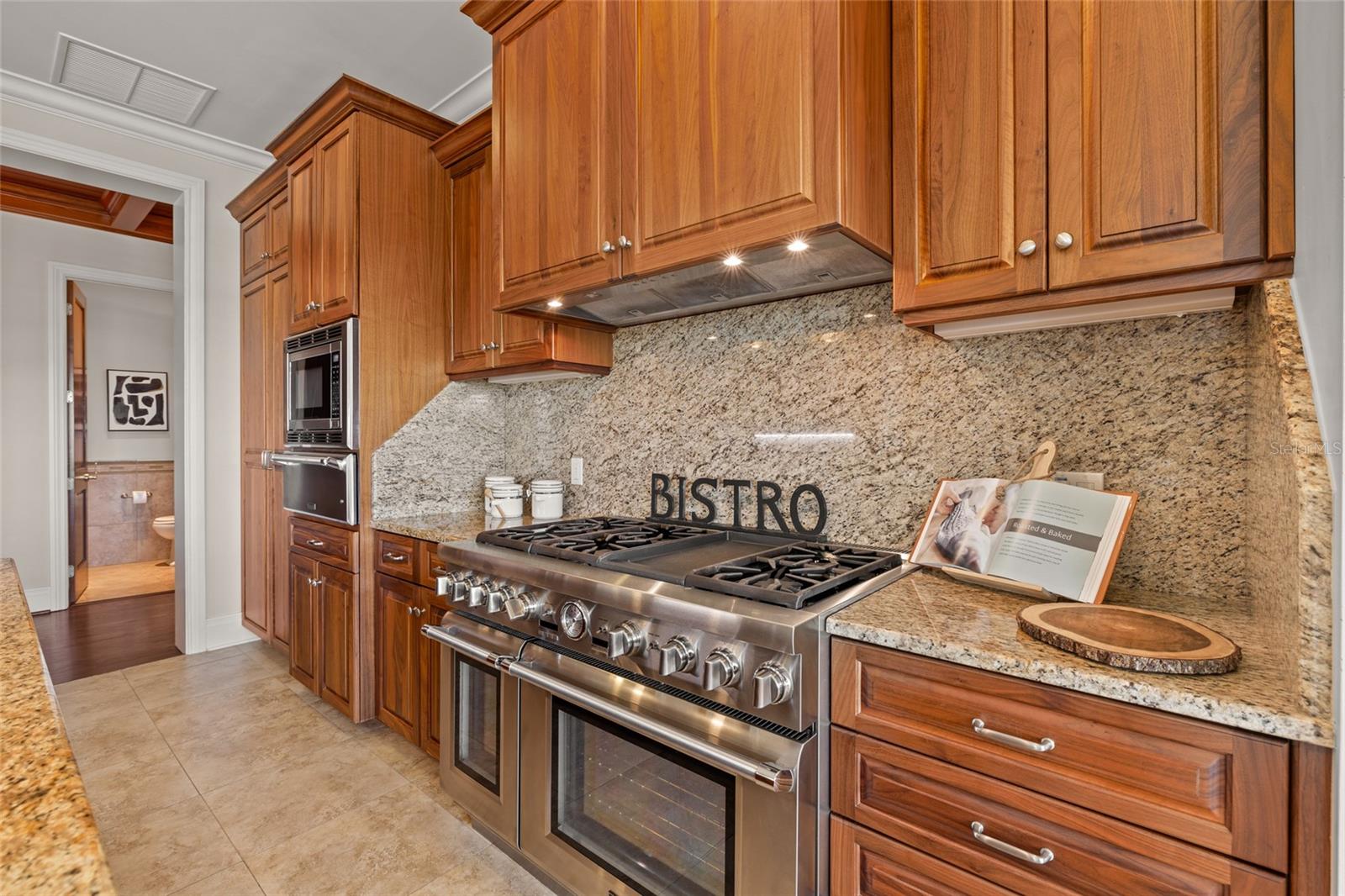 Gas cooking (vented above), double ovens, warming drawer and microwave.