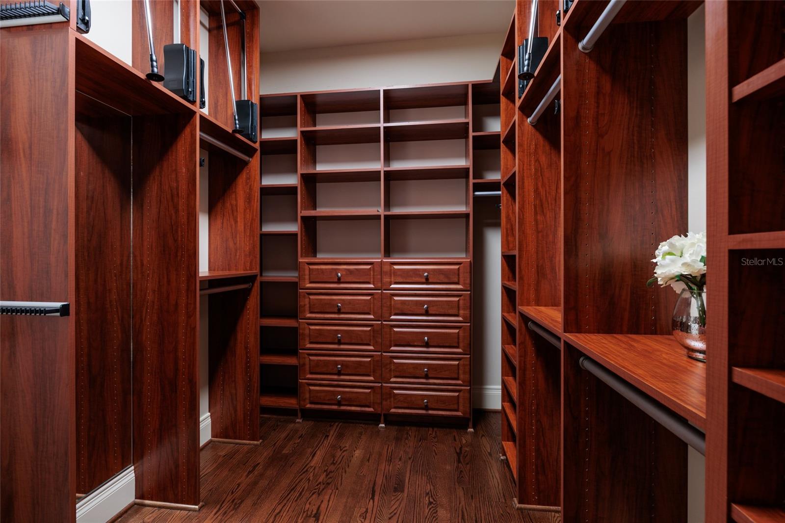 One view of primary closet with all the organizer/storage "things"!