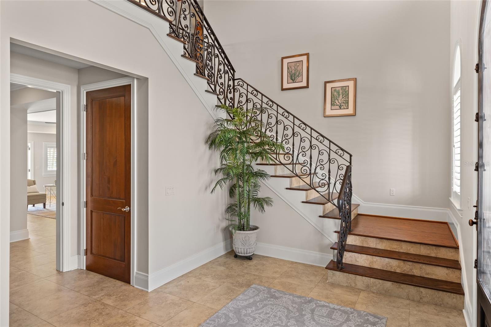 Custom wrought iron staircase and millwork throughout.