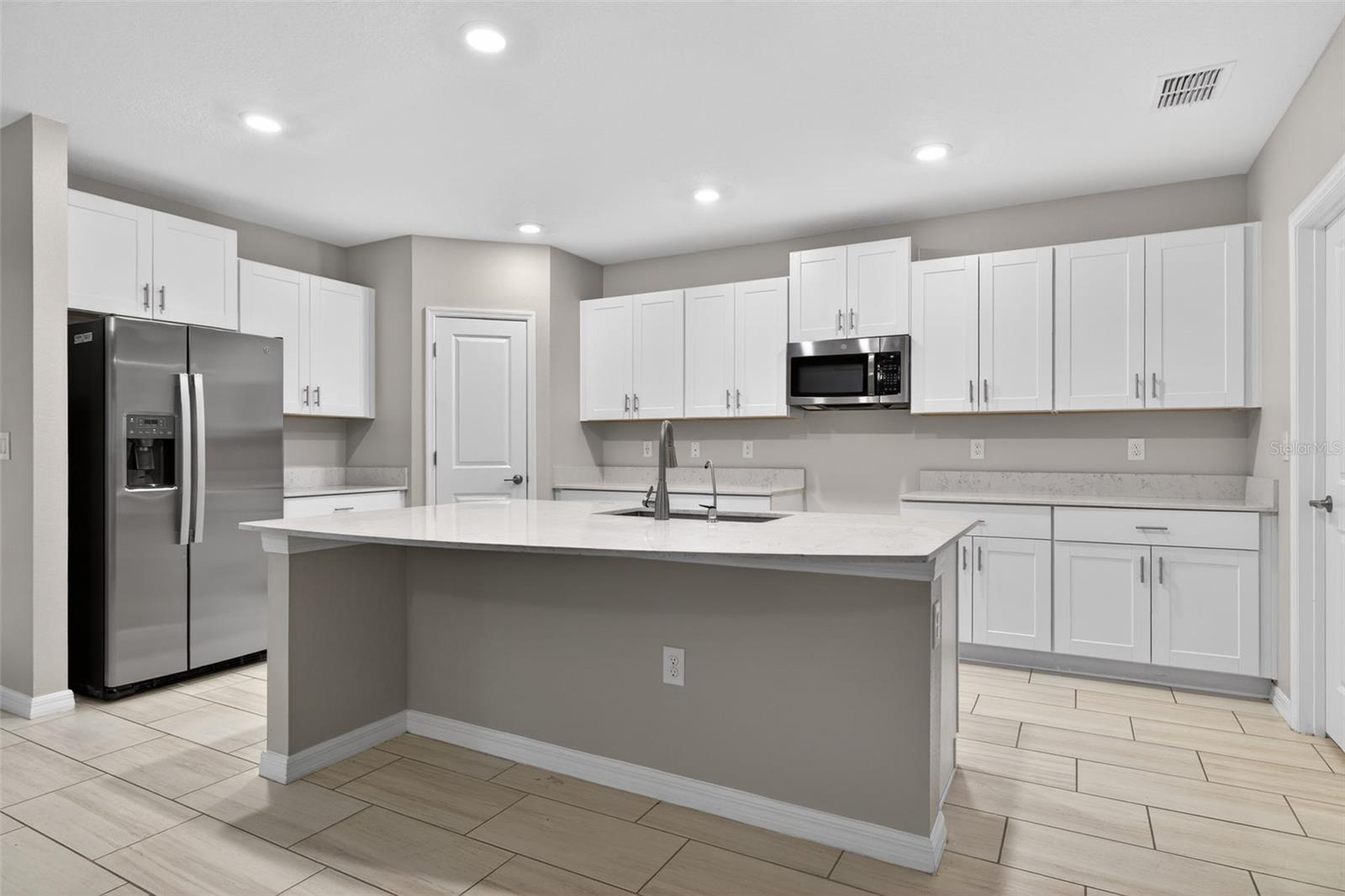 Stunning Chefs Kitchen with Quartz, White Shaker Cabinets and Spacious Island