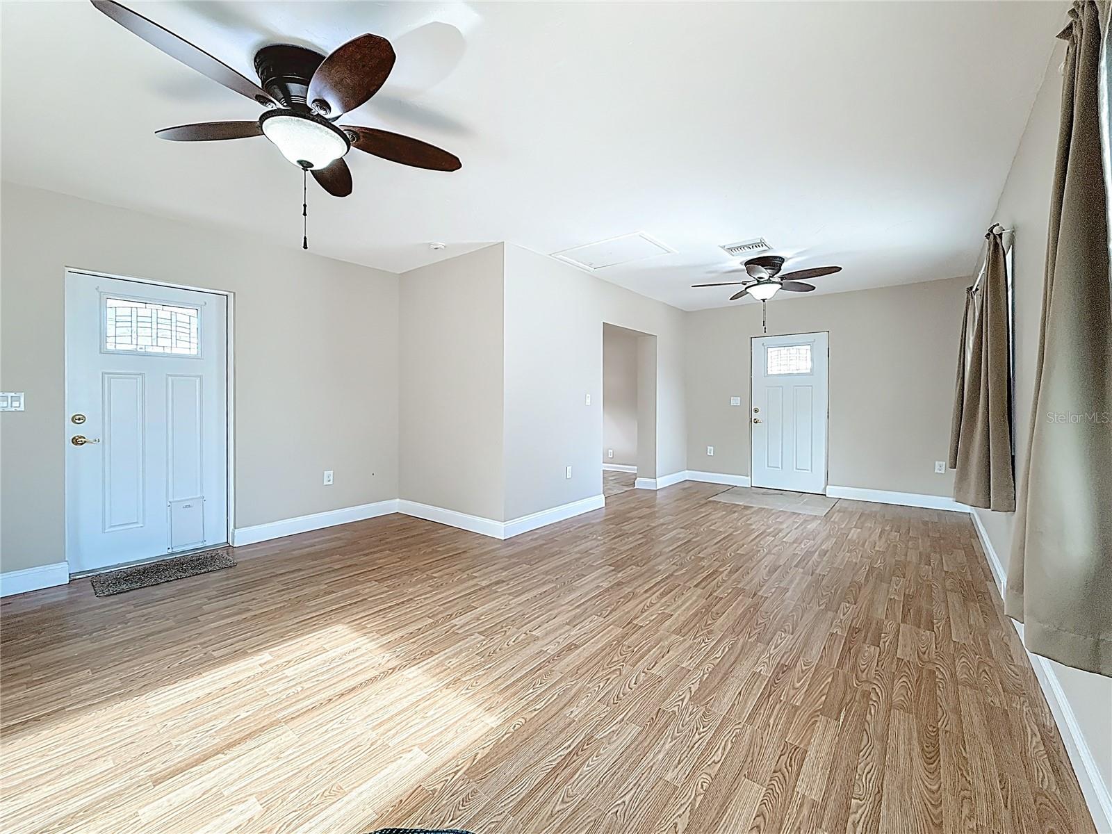 Apartment Living Room showing Front door & Back door to yard.