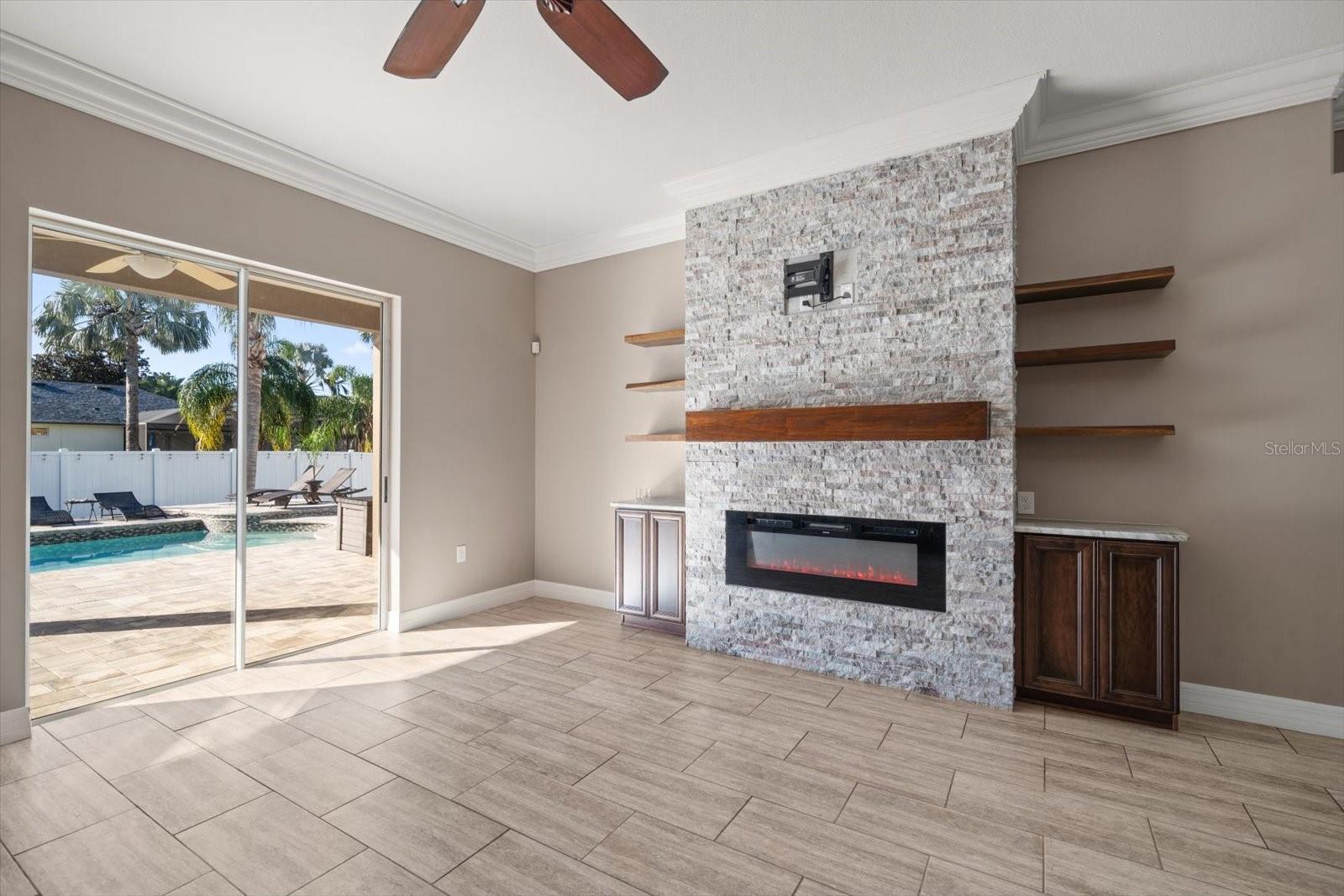 Custom Feature Wall with Stacked Stone Floating Shelves and Electric Fireplace