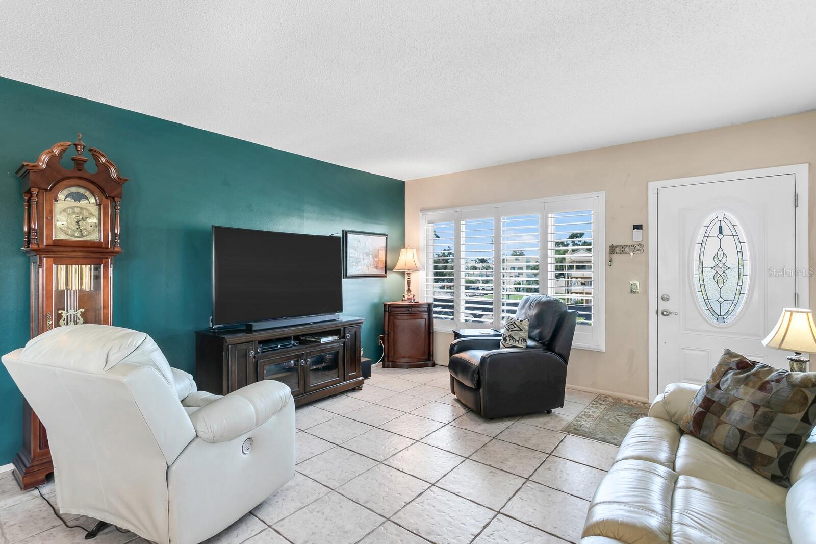 Living Room With Loads Of Windows & Plantation Shutters