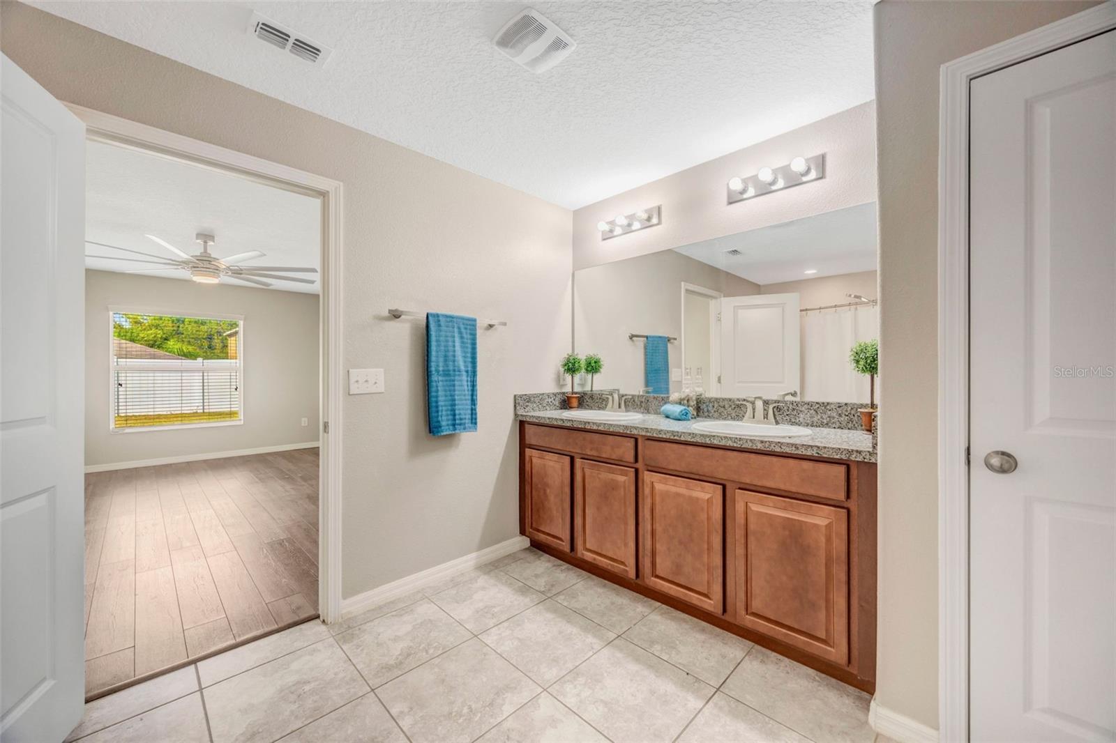 Large Primary En Suite Bathroom w/ dual sinks, walk in shower, and huge closet!