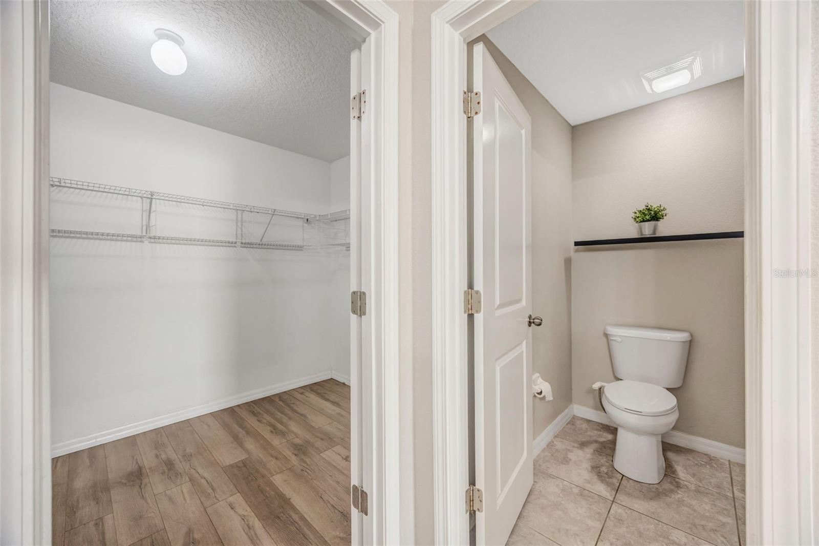 Large Primary En Suite Bathroom w/ dual sinks, walk in shower, and huge closet!