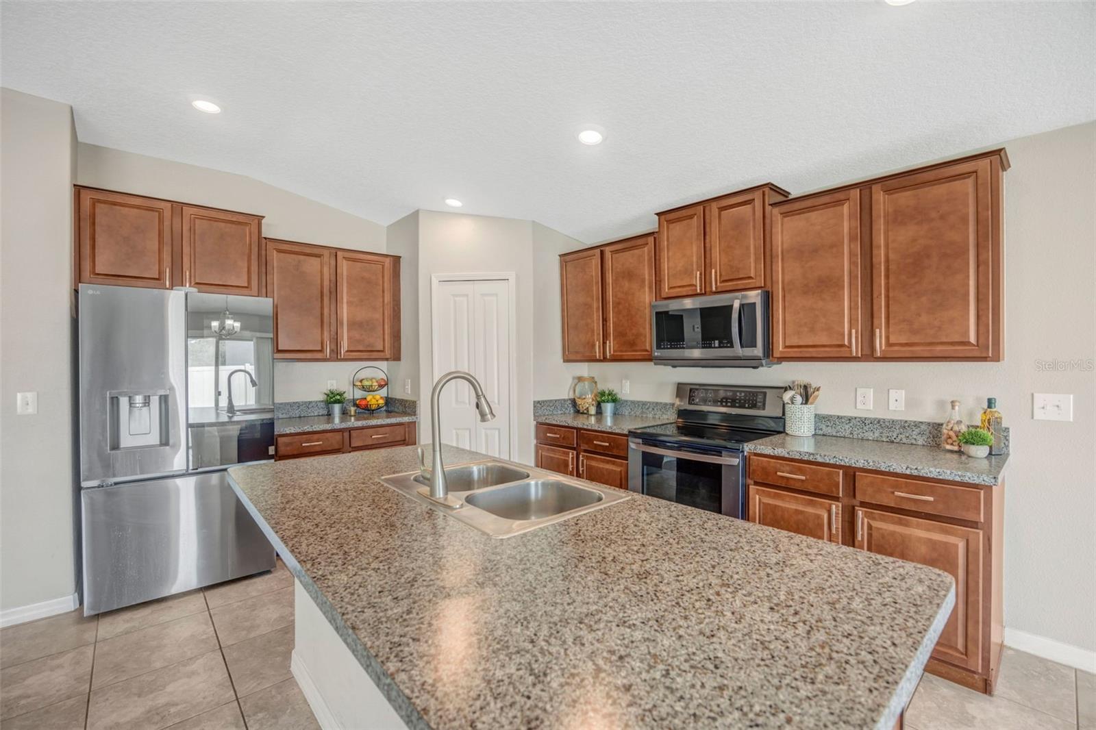 Open Kitchen w/ walk in pantry, island, and breakfast bar