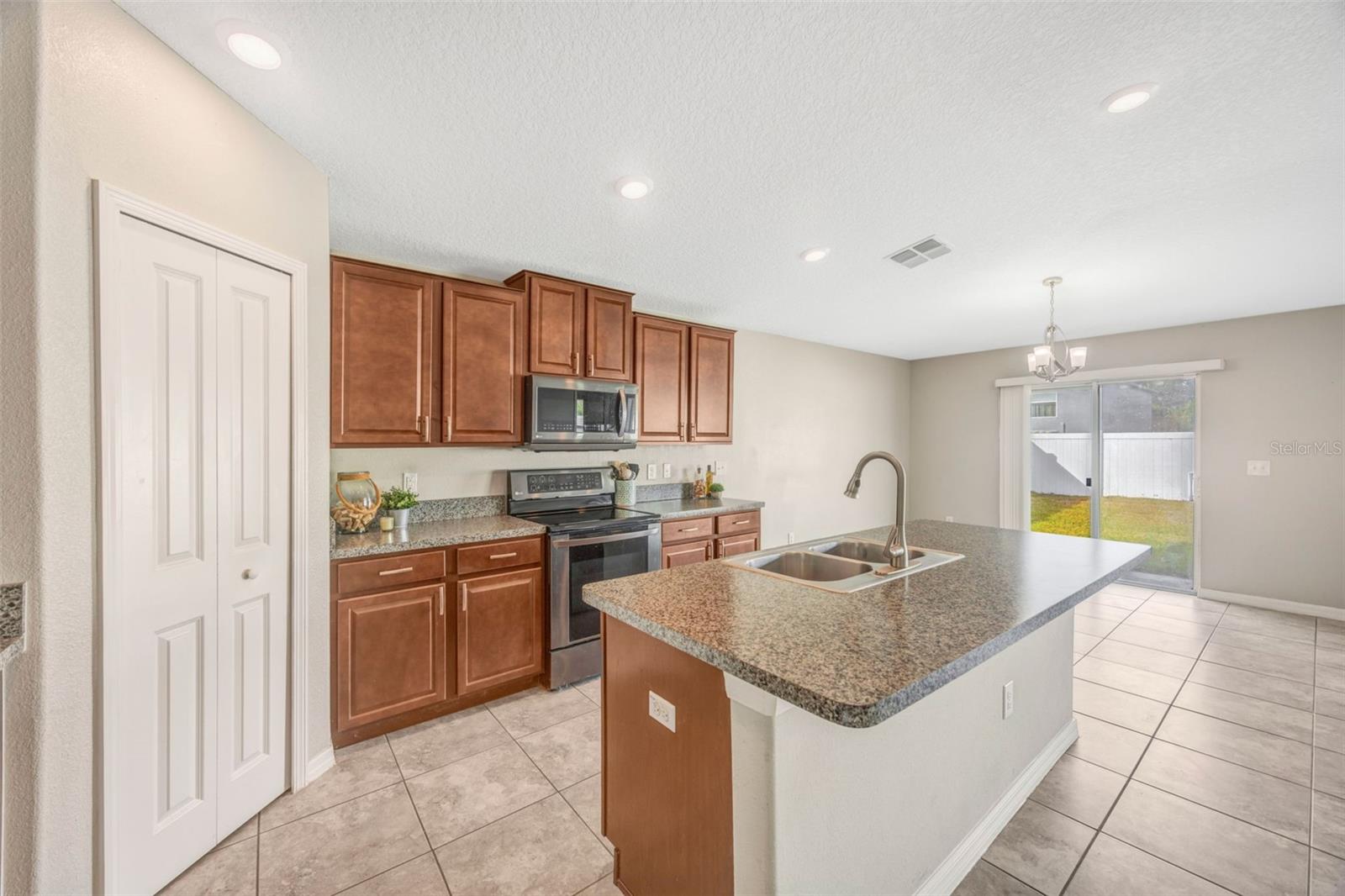 Open Kitchen w/ walk in pantry, island, and breakfast bar