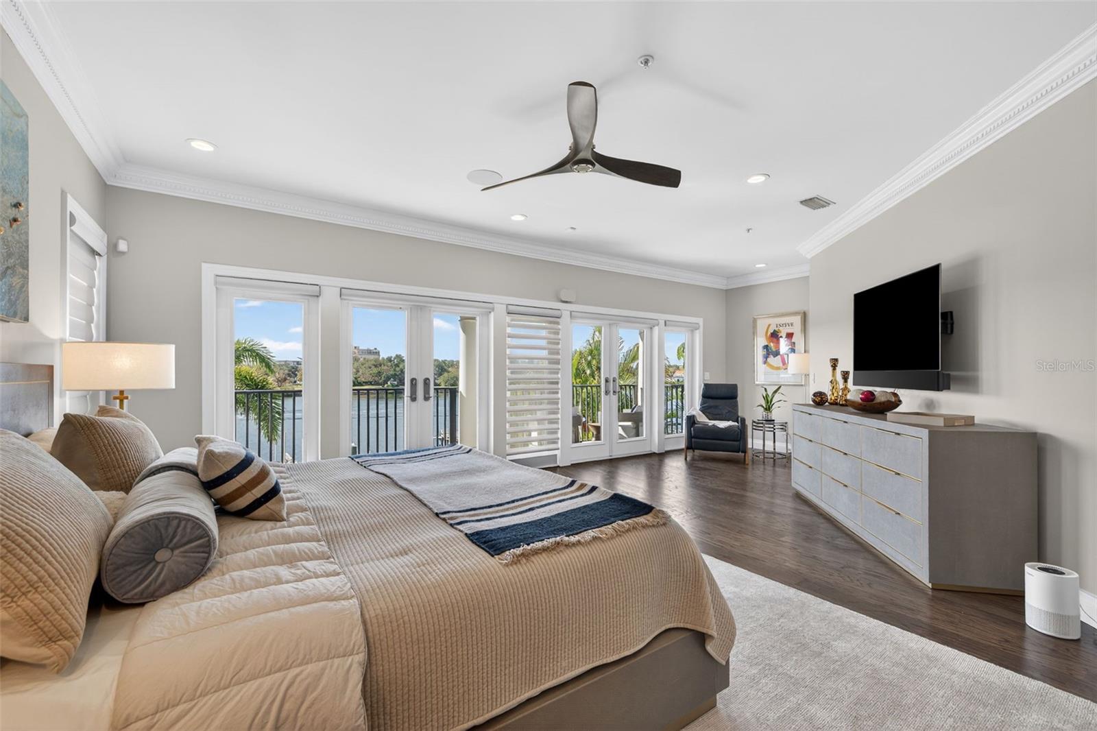 Spacious primary suite offering serene water views and a true retreat-like ambiance.