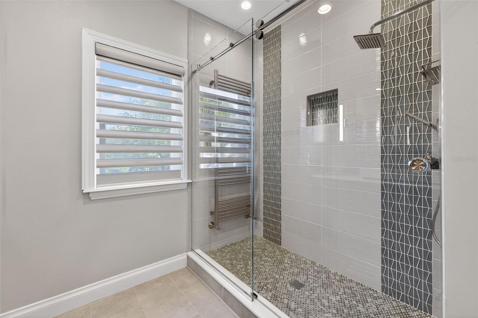 Well-appointed ensuite bath with upscale fixtures.
