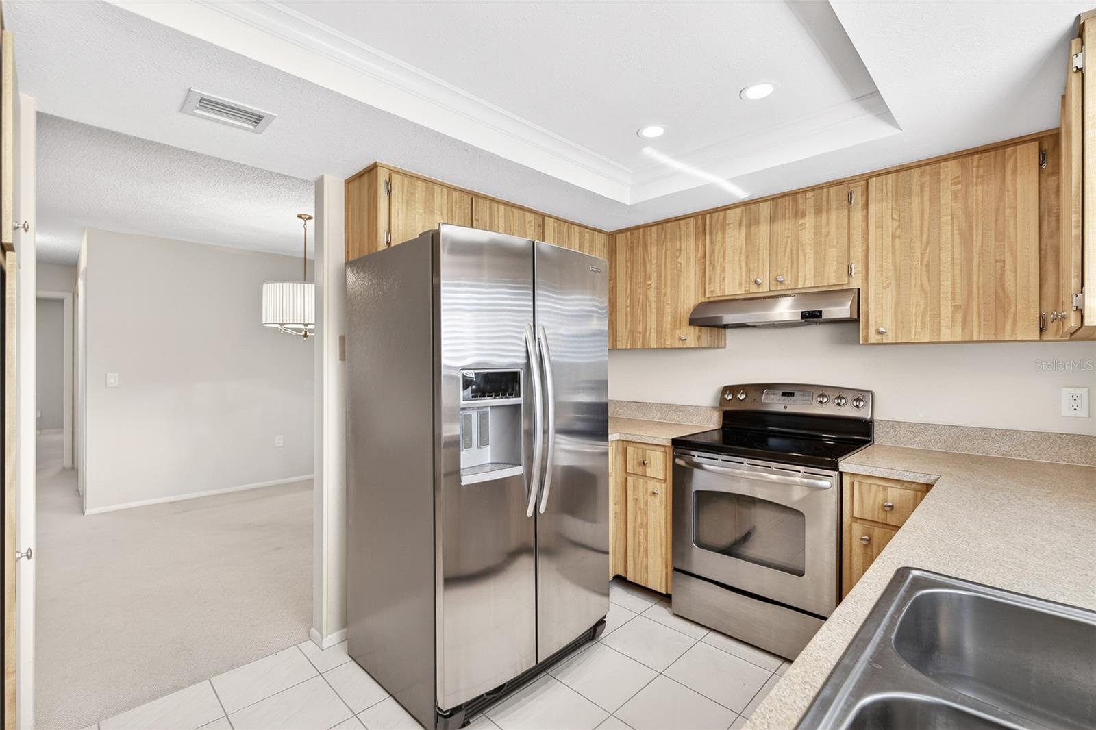 Bright Kitchen with Stainless Appliances and Wine Fridge