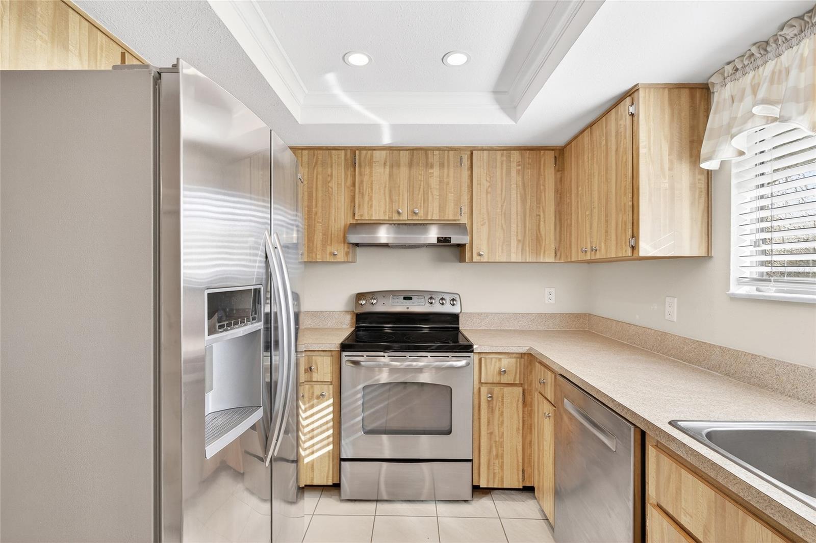 Bright Kitchen with Stainless Appliances and Wine Fridge