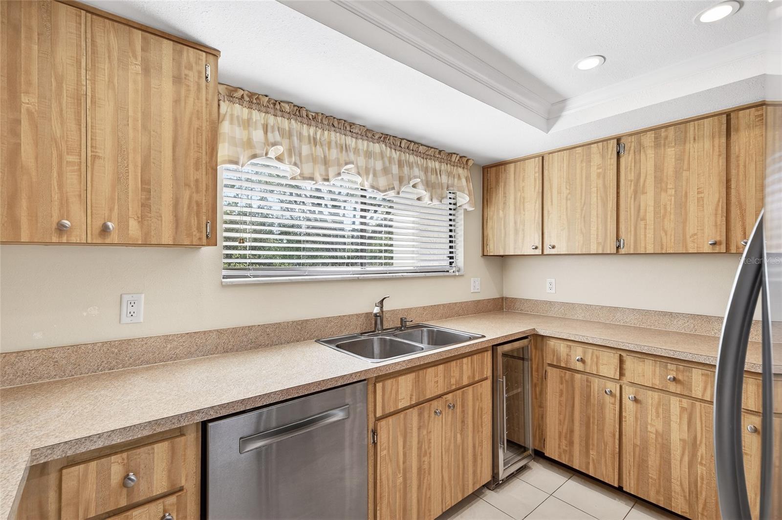 Bright Kitchen with Stainless Appliances and Wine Fridge