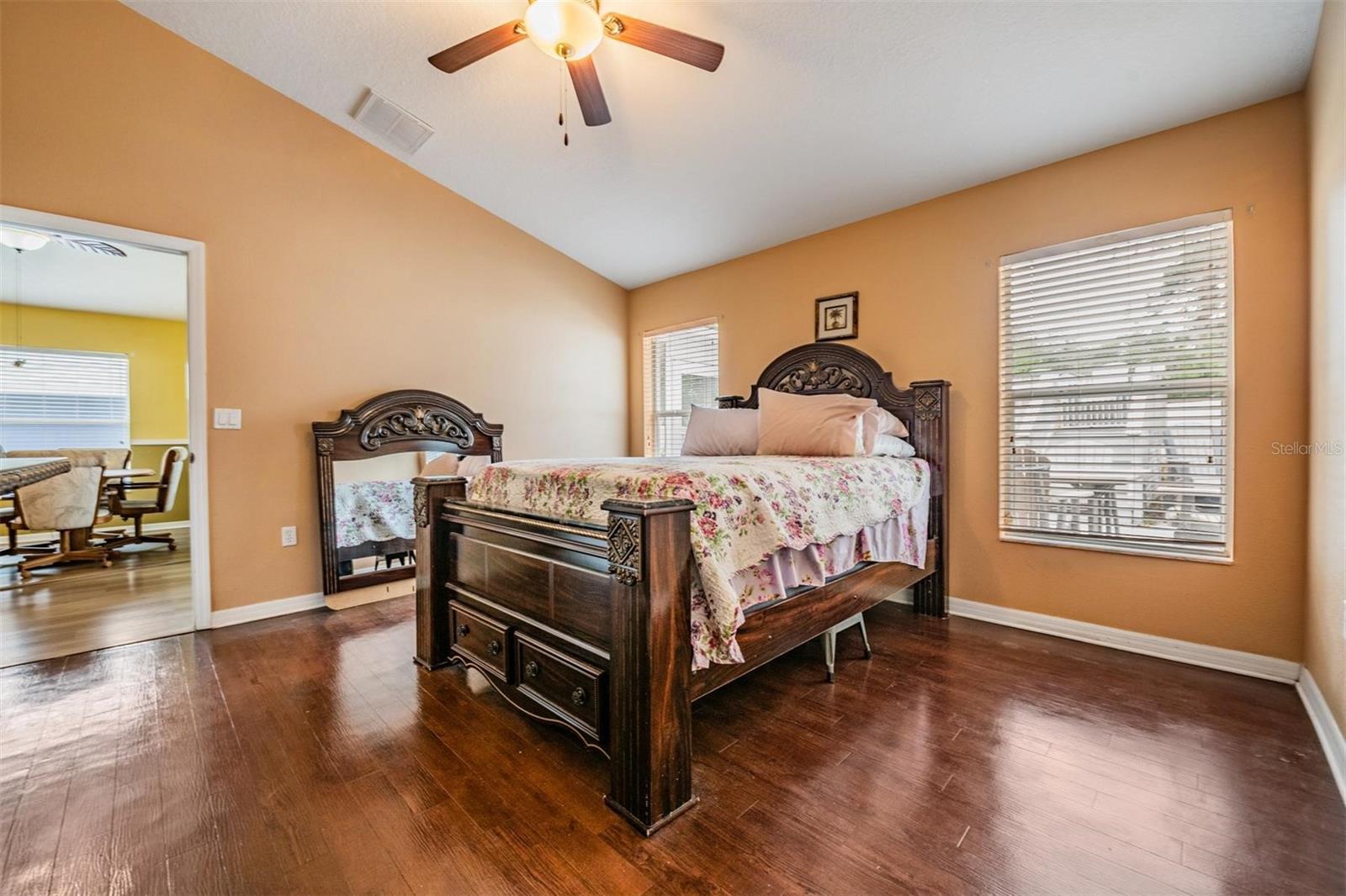 Primary bedroom with vaulted ceilings.