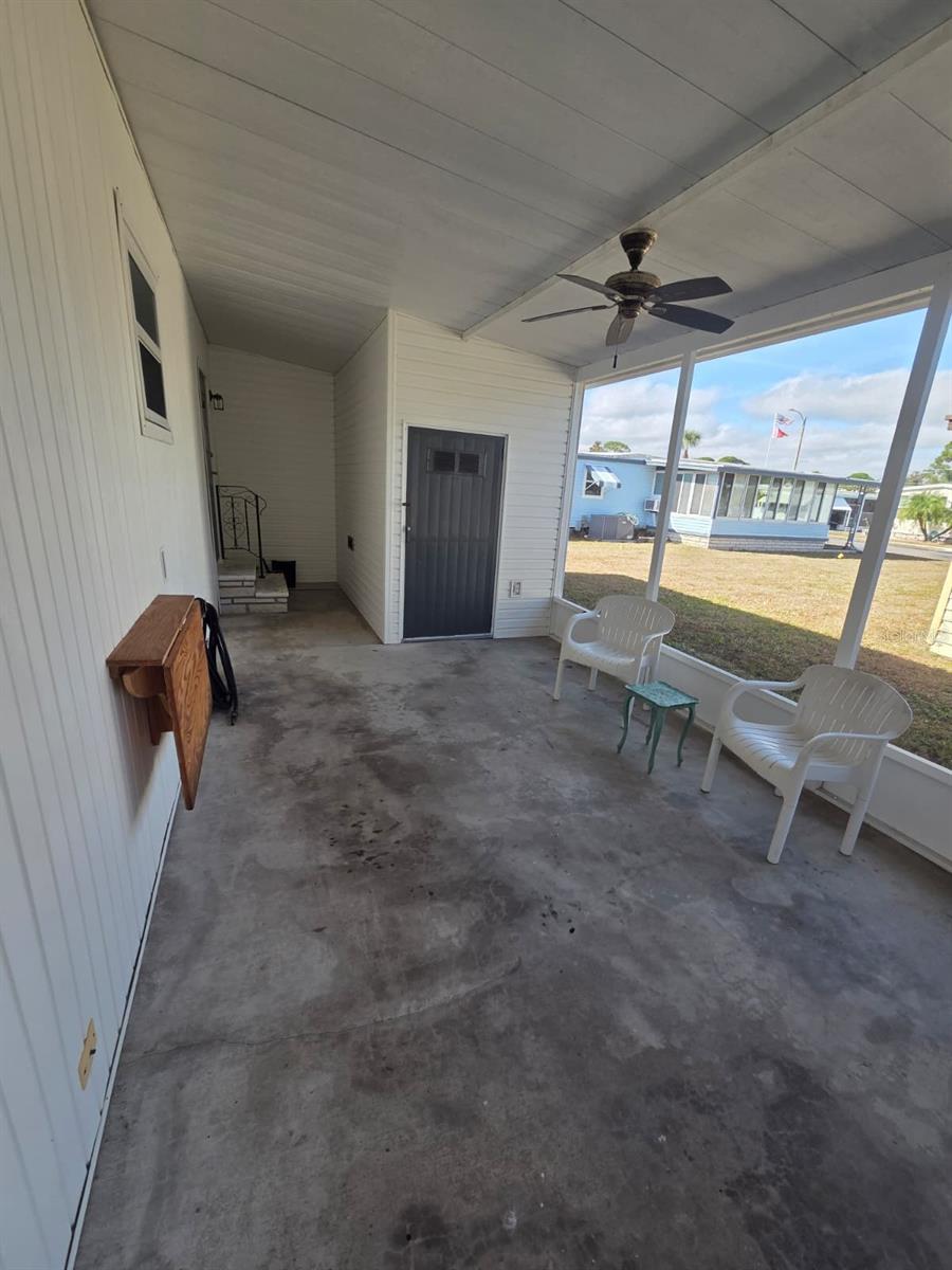 Screened in porch that is connected to the carport