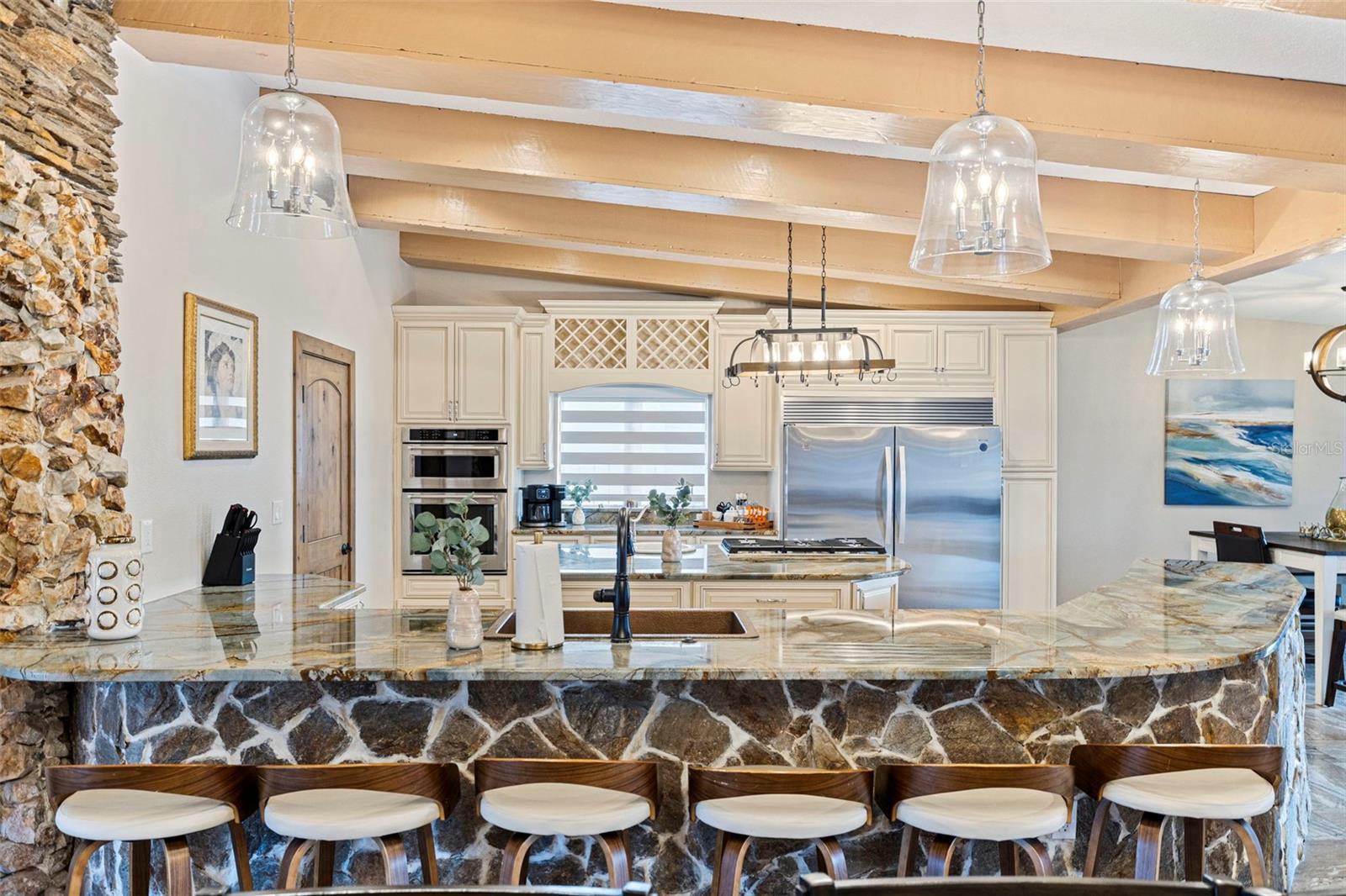 Exquisite kitchen space with large peninsula bar.