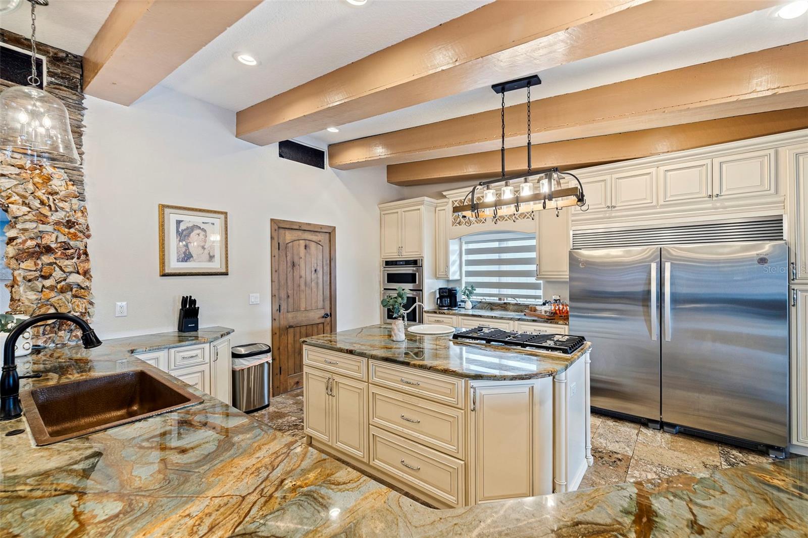 Kitchen with island and commercial refrigerator
