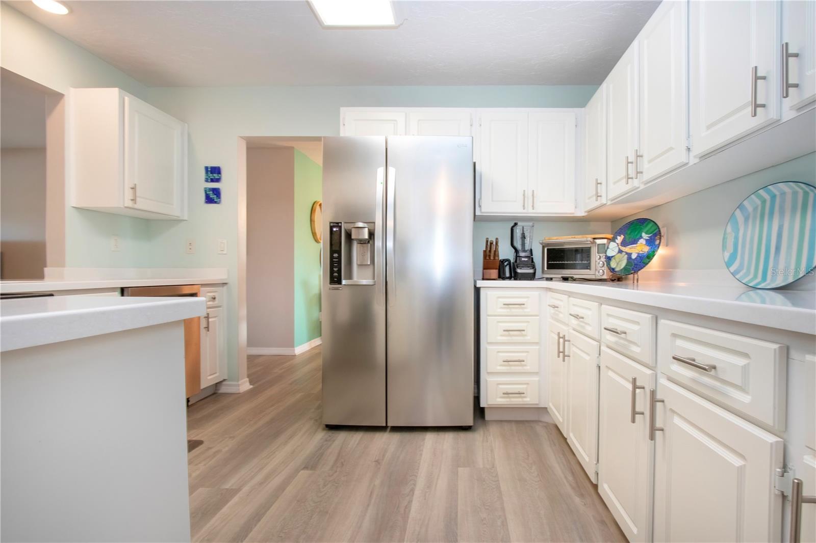 Kitchen w/lots of storage cabinets and solid surface counters