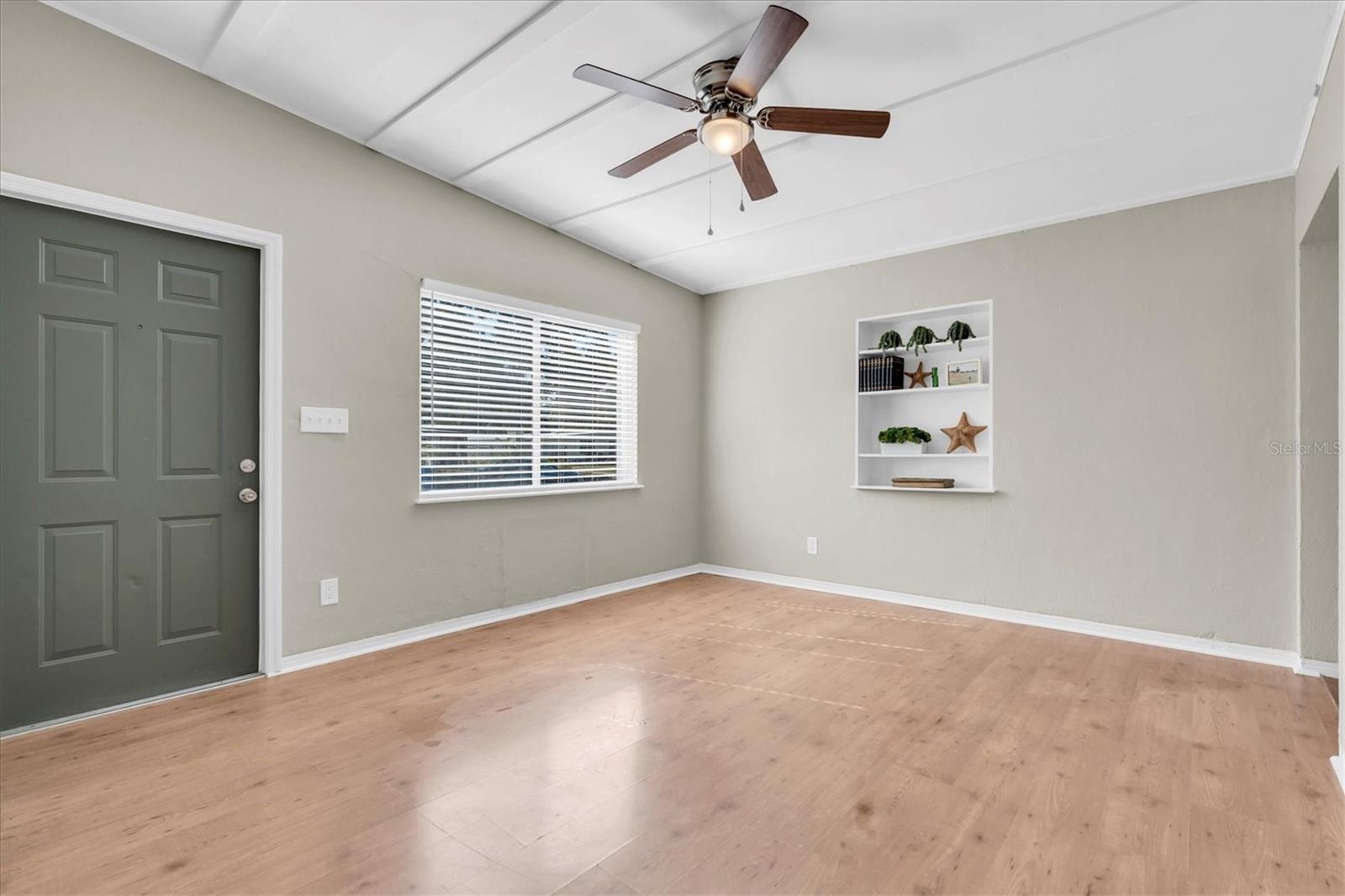 The living room has built in shelves.