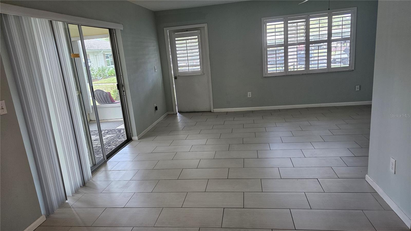 1902 Dandridge St unit 12 front room, front door with Plantation Shutter and Sliding glass door
