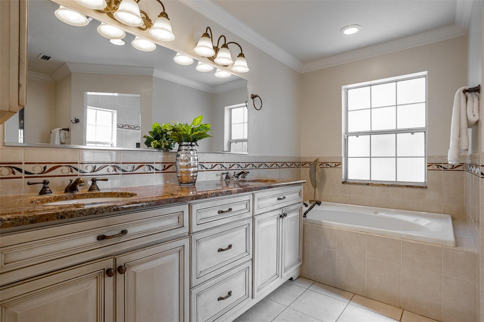 Spacious primary bath with double sinks, a soaker tub and a large, separate walk-in shower