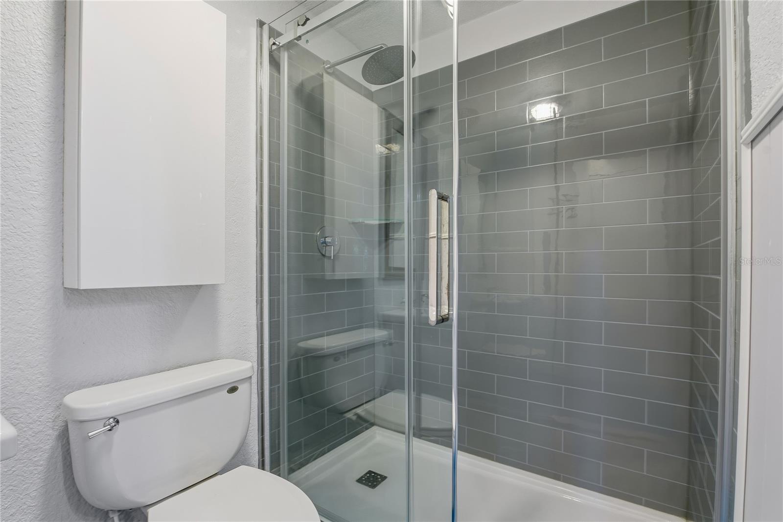 WALK IN SHOWER IN THE DOWNSTAIRS BATHROOM