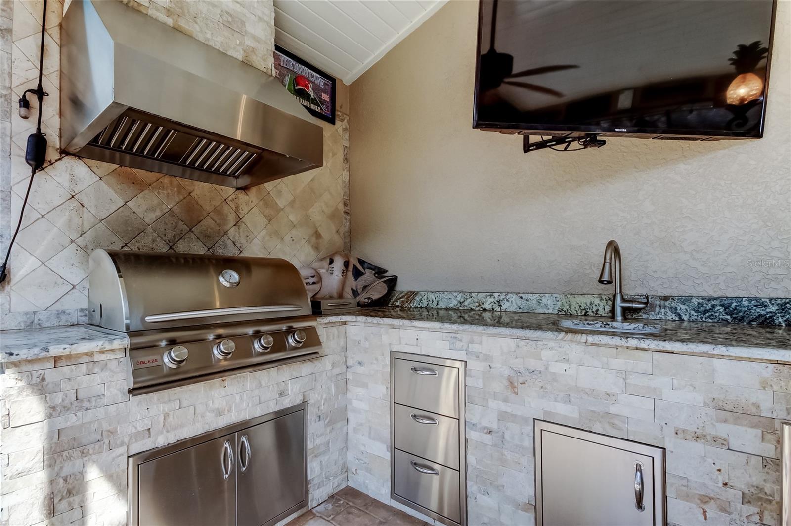 Built-in Poolside Kitchen a bar that seats six friends