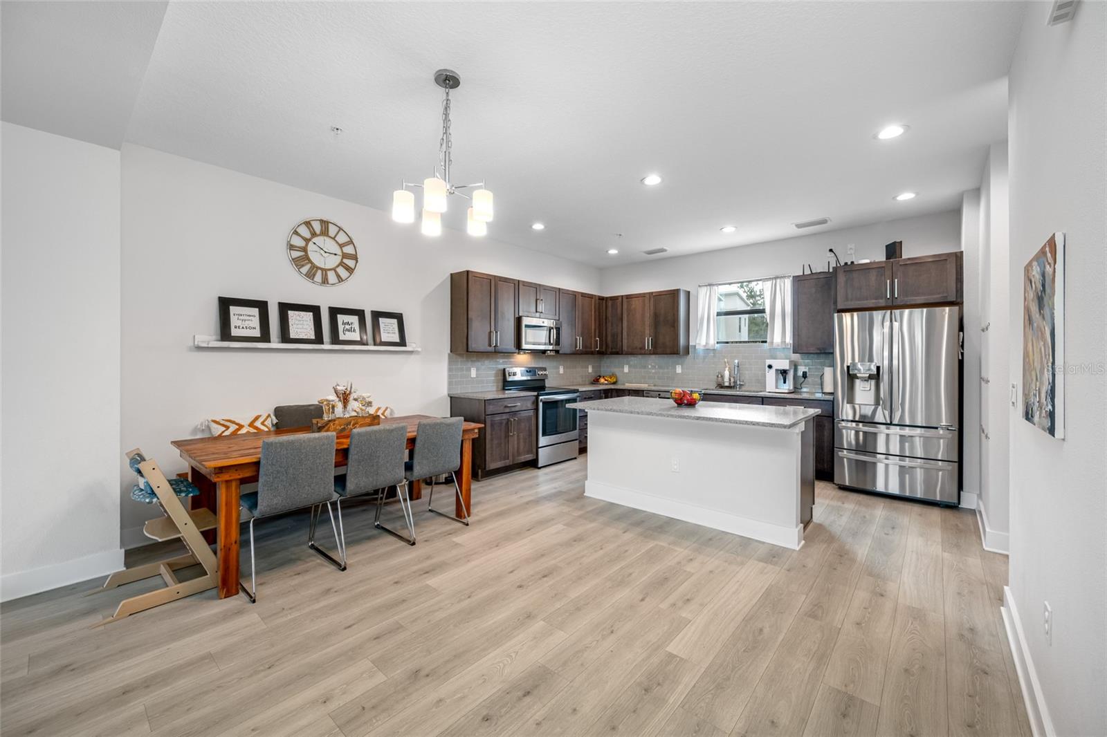 Gourmet kitchen with quartz countertops, Open to the dinning and living room. 10 ft ceilings and oversized windows let in lots of natural light. Second Floor
