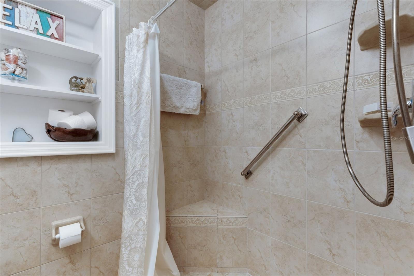 Guest bath with tiled shower built in seat